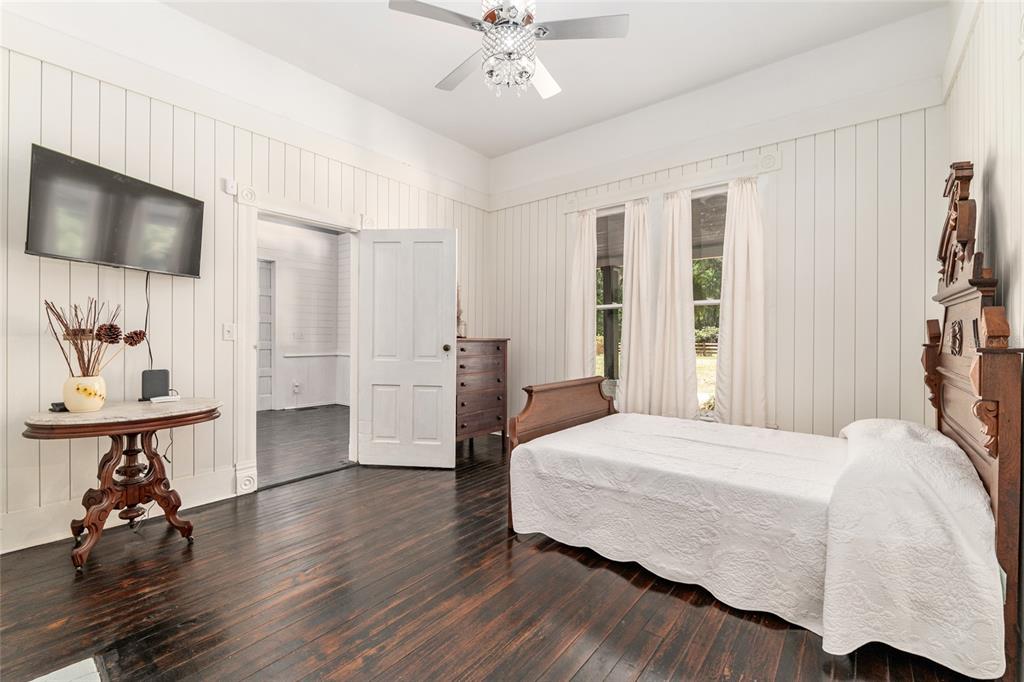 19451 Southeast 2 Street Williston, FL 32696 - Photo 52 of 99 a bedroom with a bed a mirror and furniture