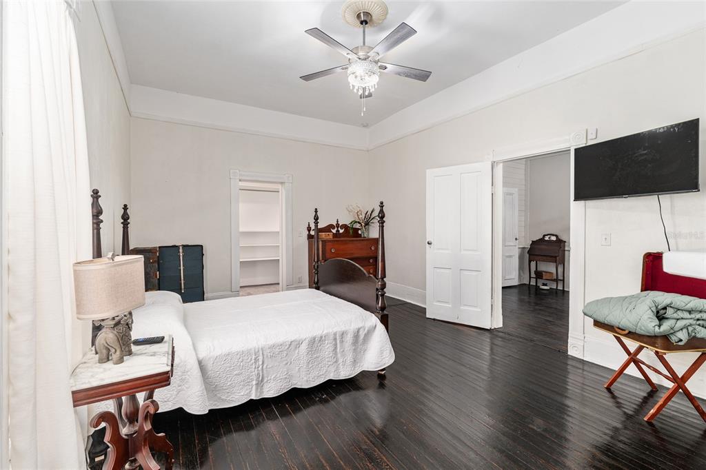 19451 Southeast 2 Street Williston, FL 32696 - Photo 61 of 99 a bedroom with a bed and a chandelier