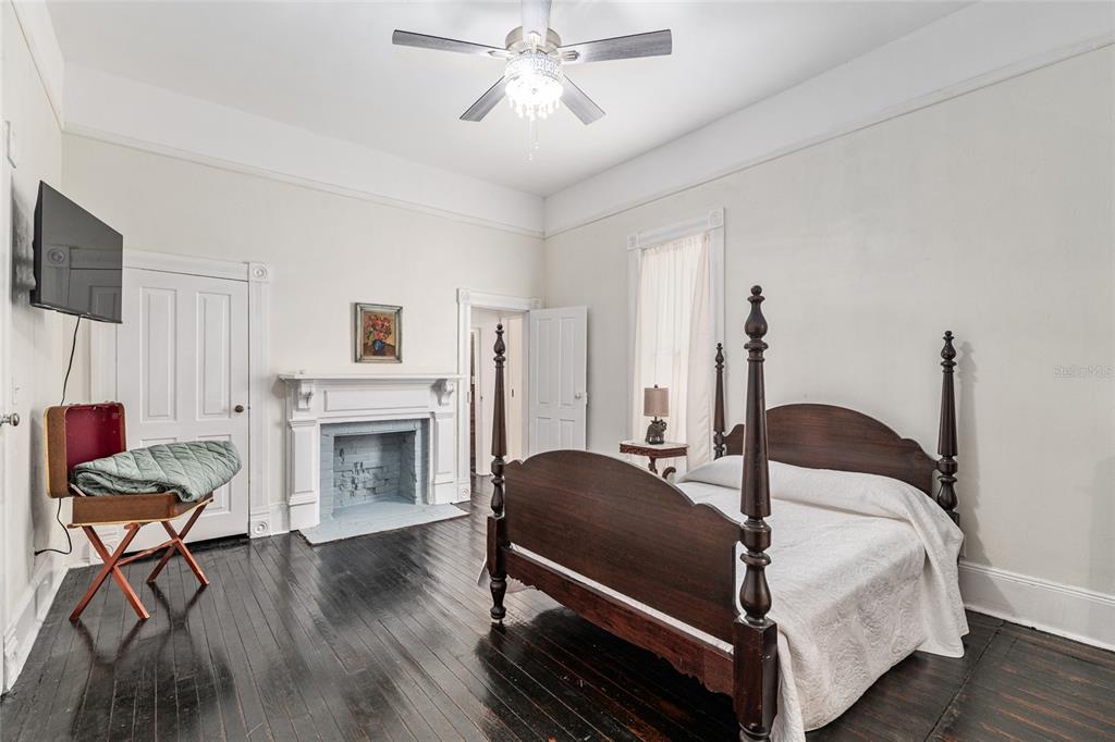 19451 Southeast 2 Street Williston, FL 32696 - Photo 62 of 99 a bedroom with a bed and a fireplace