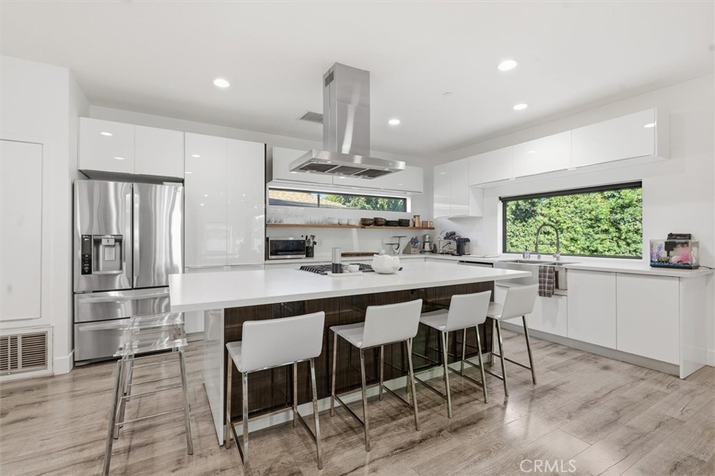 5487 Blanco Way Culver City, CA 90230 - Photo 14 of 58 a kitchen with stainless steel appliances a dining table chairs and window