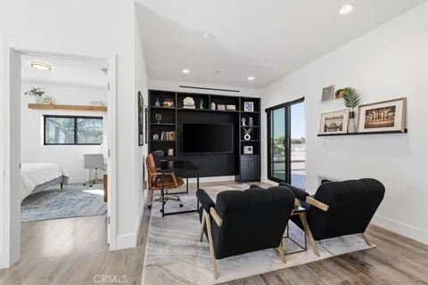 a bedroom with a large bed and a tv