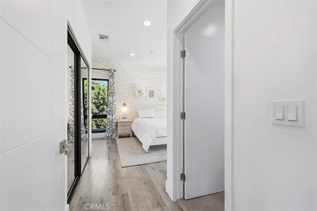 a bedroom with a large bed and a walk in closet