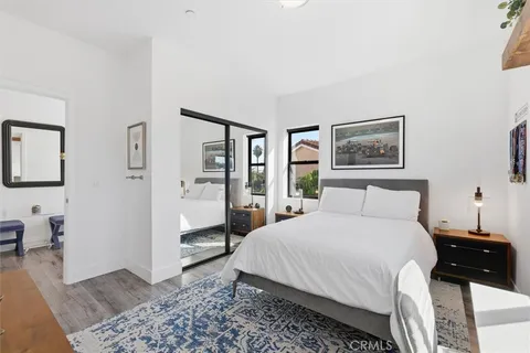 a bedroom with a large bed and a chandelier