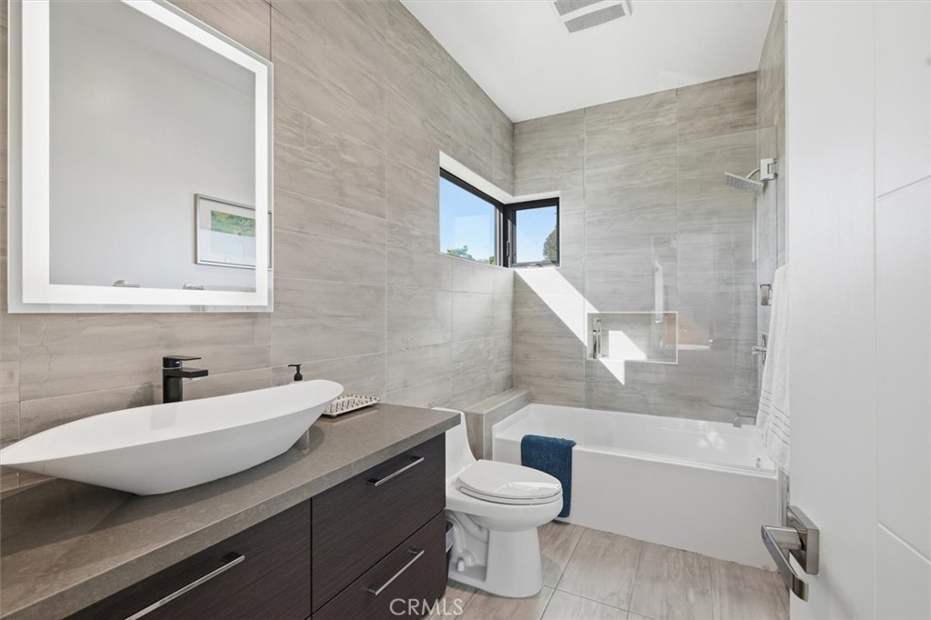 5487 Blanco Way Culver City, CA 90230 - Photo 38 of 58 a bathroom with a granite countertop sink toilet and shower