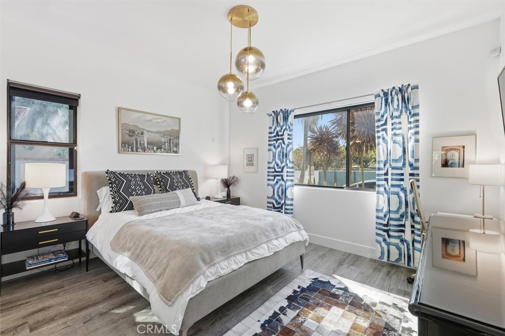 5487 Blanco Way Culver City, CA 90230 - Photo 39 of 58 a bedroom with a large bed and a chandelier