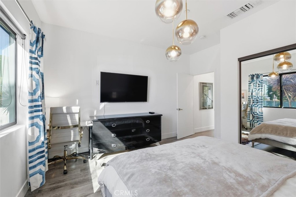 5487 Blanco Way Culver City, CA 90230 - Photo 40 of 58 a spacious bedroom with a bed and a flat tv screen on dresser