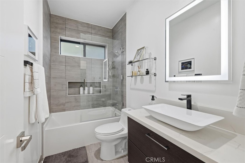 5487 Blanco Way Culver City, CA 90230 - Photo 42 of 58 a bathroom with a granite countertop sink toilet and shower