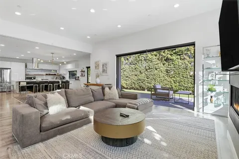 a kitchen with a stove a sink a window and dining table