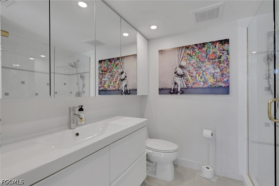 9 High Point Circle North, Unit 101 Naples, FL 34103 - Photo 22 of 49 a bathroom with a sink a toilet and a bathtub