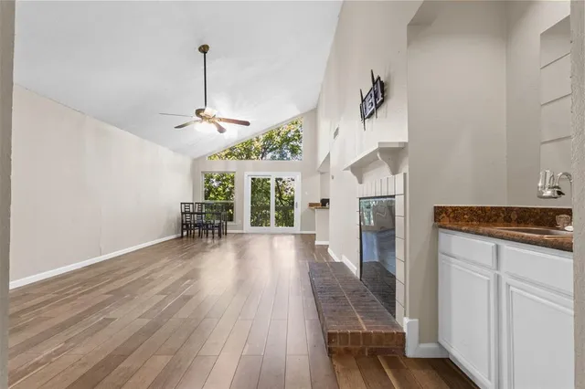 a view of a livingroom with wooden floor and a ceiling fan