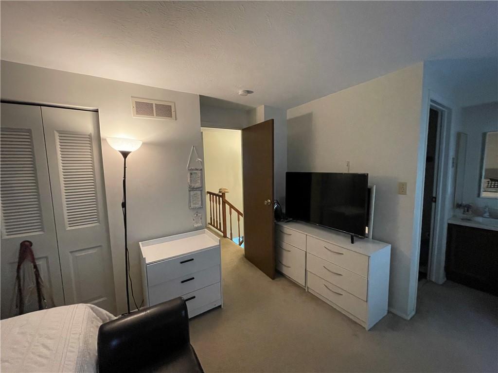 271 Quail Run Road Venetia, PA 15367 - Photo 14 of 30 a room with a flat screen tv on the dresser and a refrigerator