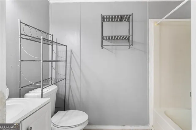 a white toilet sitting next to a bathroom sink