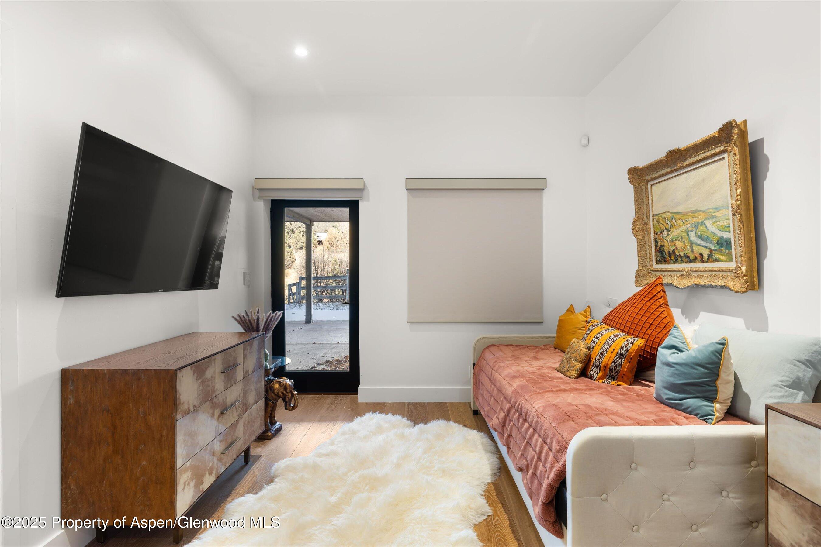 400 Meadow Lane Basalt, CO 81621 - Photo 23 of 28 a bedroom with a bed and a flat screen television
