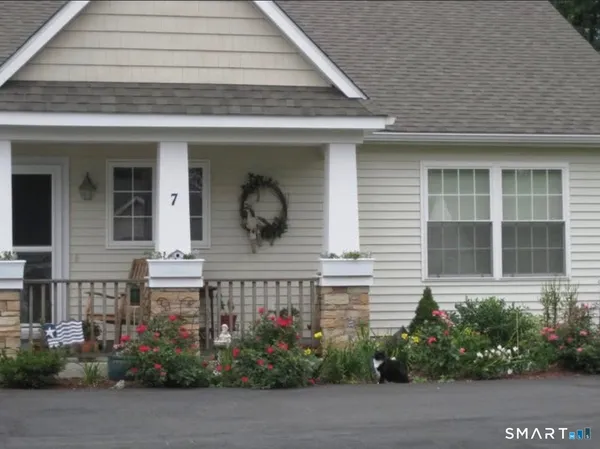 a front view of house with a garden