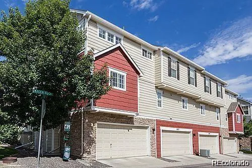 a front view of a house with a tree
