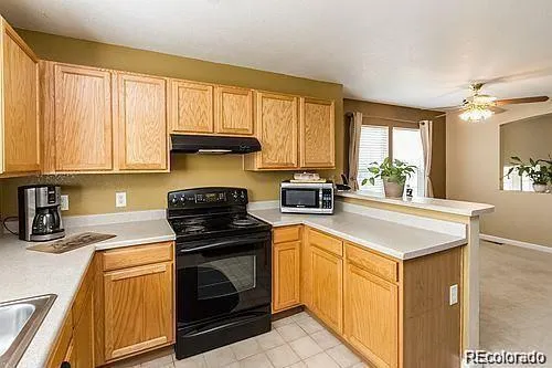 a kitchen with a stove a sink and a microwave