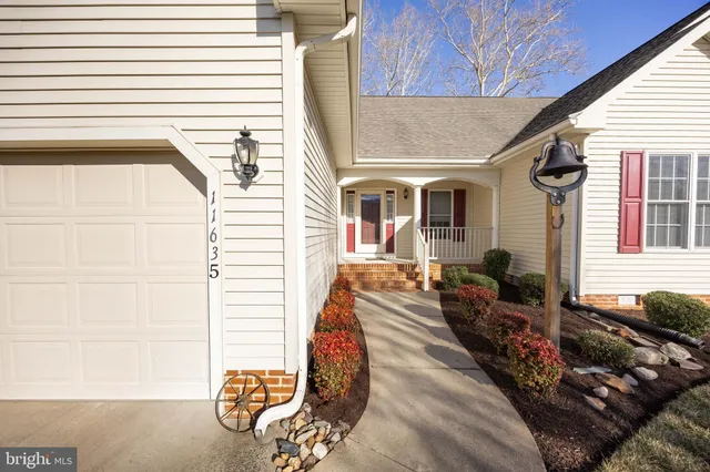 a kitchen with stainless steel appliances granite countertop a sink and a refrigerator