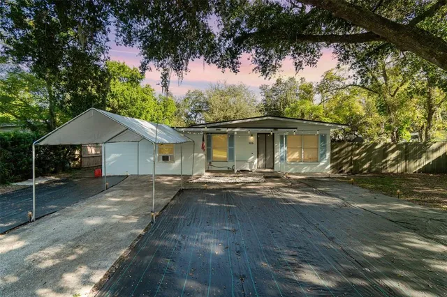 a front view of a house with a garden and patio