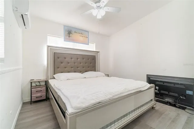 a bedroom with a bed and a chandelier