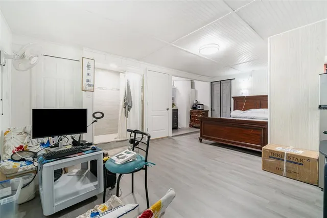 a view of a workspace with furniture and a bathroom