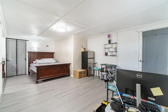 a bedroom with furniture and wooden floor