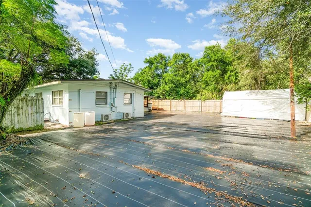 a view of a backyard with large trees
