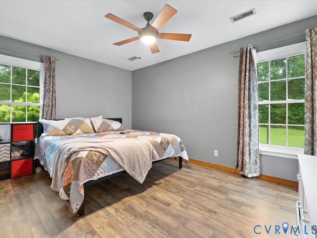 3695 Three Chopt Road Gum Spring, VA 23065 - Photo 25 of 55 Bedroom featuring wood-finish flooring, two window