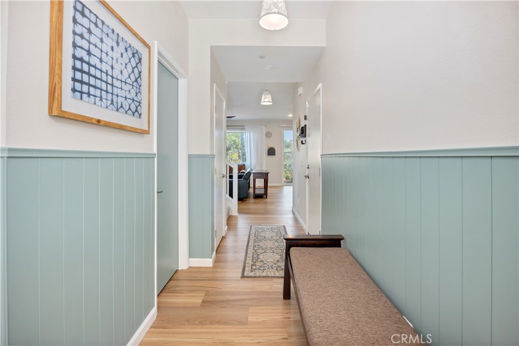 34758 Criollo Way Fallbrook, CA 92028 - Photo 2 of 25 a view of a hallway with wooden floor and a living room