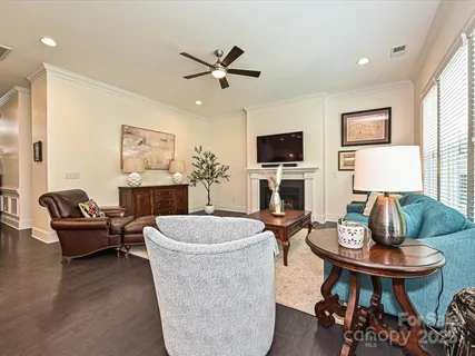 a living room with fireplace furniture and a wooden floor
