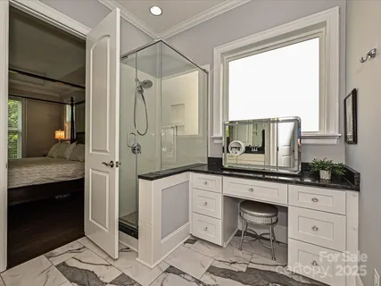 a spacious bathroom with a granite countertop sink mirror and shower