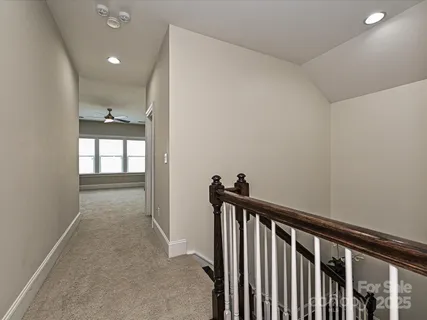 a living room with furniture and a ceiling fan
