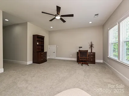 a living room with furniture and a ceiling fan