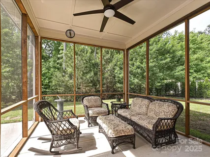 a view of backyard with seating area and green space