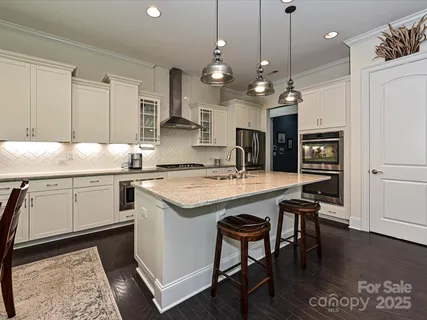 a kitchen with a stove a refrigerator and a dining table