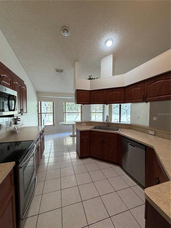 1716 Percheron Drive Trinity, FL 34655 - Photo 13 of 29 a kitchen with granite countertop a stove a sink and a microwave