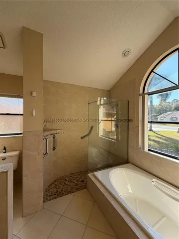 a bathroom with a granite countertop sink a toilet and a shower