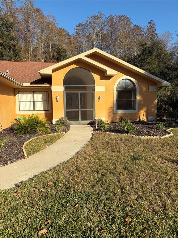 1716 Percheron Drive Trinity, FL 34655 - Photo 2 of 29 a front view of a house with a yard