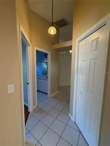 a view of a hallway to rooms