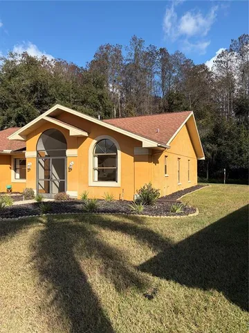 a view of house with river and trees around