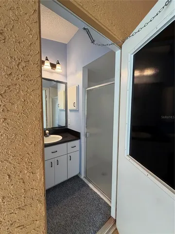a bathroom with a double vanity sink and mirror