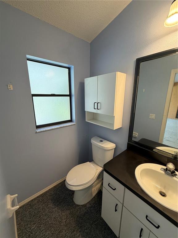1716 Percheron Drive Trinity, FL 34655 - Photo 8 of 29 a bathroom with a granite countertop toilet sink and mirror