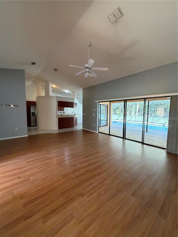 1716 Percheron Drive Trinity, FL 34655 - Photo 10 of 29 wooden floor in an empty room with a window