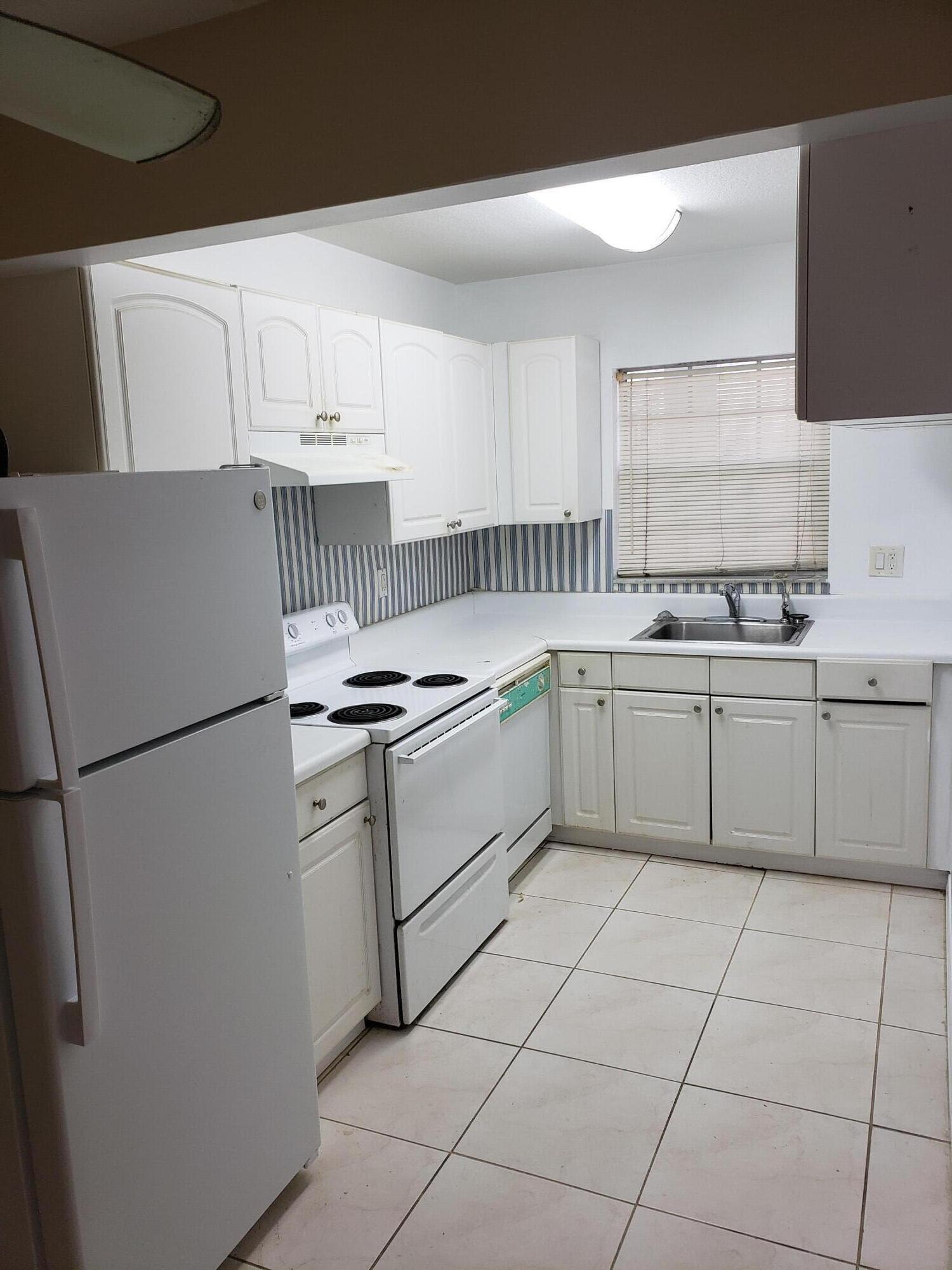 a kitchen with appliances cabinets and a sink