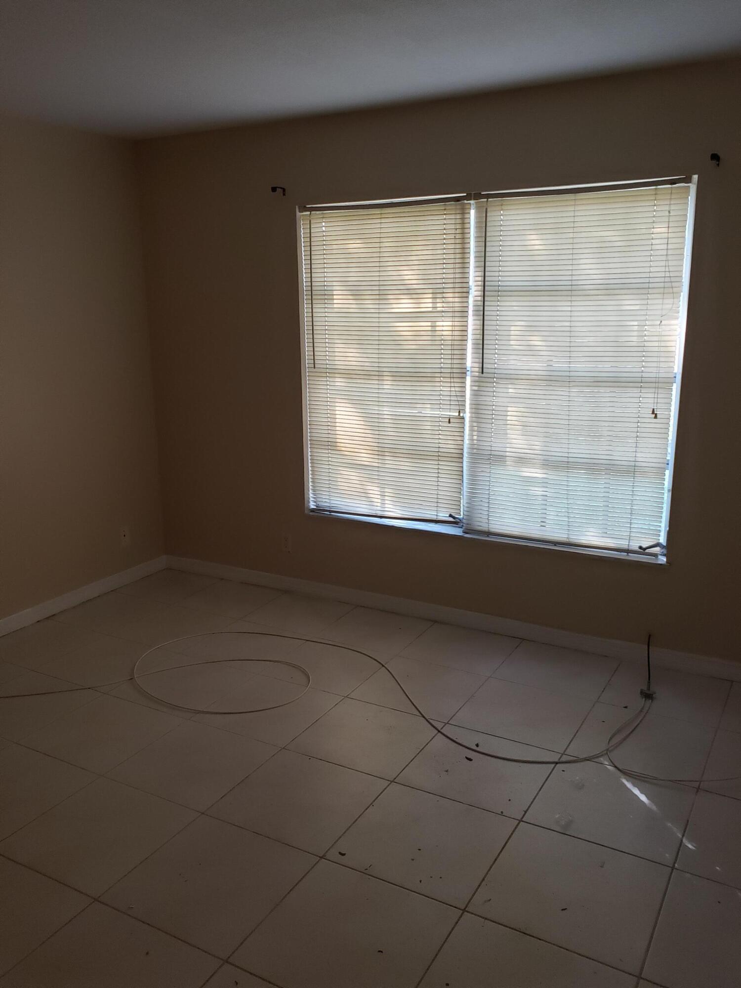 4951 Wedgewood Way, Unit 3 West Palm Beach, FL 33417 - Photo 4 of 4 a view of a room that has a window in it