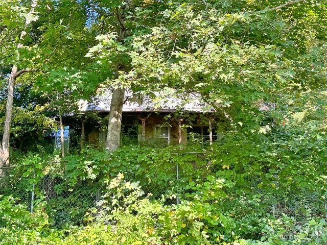 a backyard of a house with lots of green space and a fountain