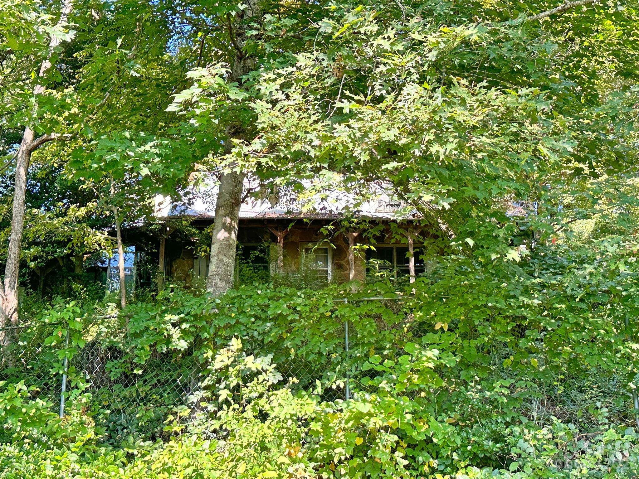a backyard of a house with lots of green space and a fountain