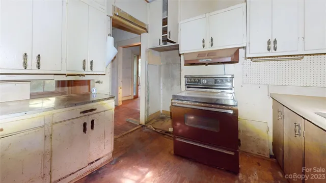 a kitchen with stainless steel appliances granite countertop a stove and a refrigerator