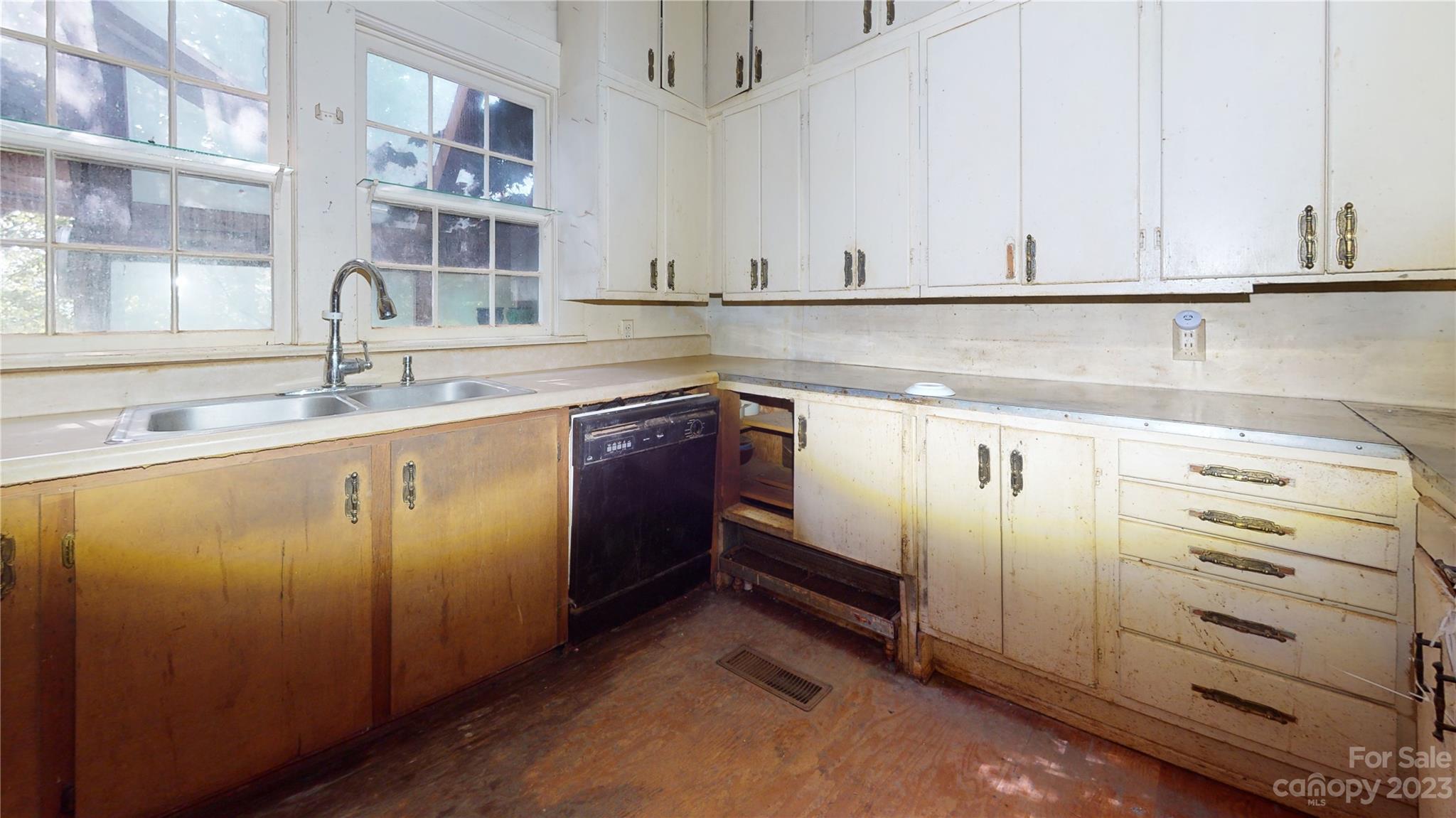 324 Buzzard's Roost Road Cullowhee, NC 28723 - Photo 13 of 18 a kitchen with stainless steel appliances granite countertop a sink and dishwasher with white cabinets