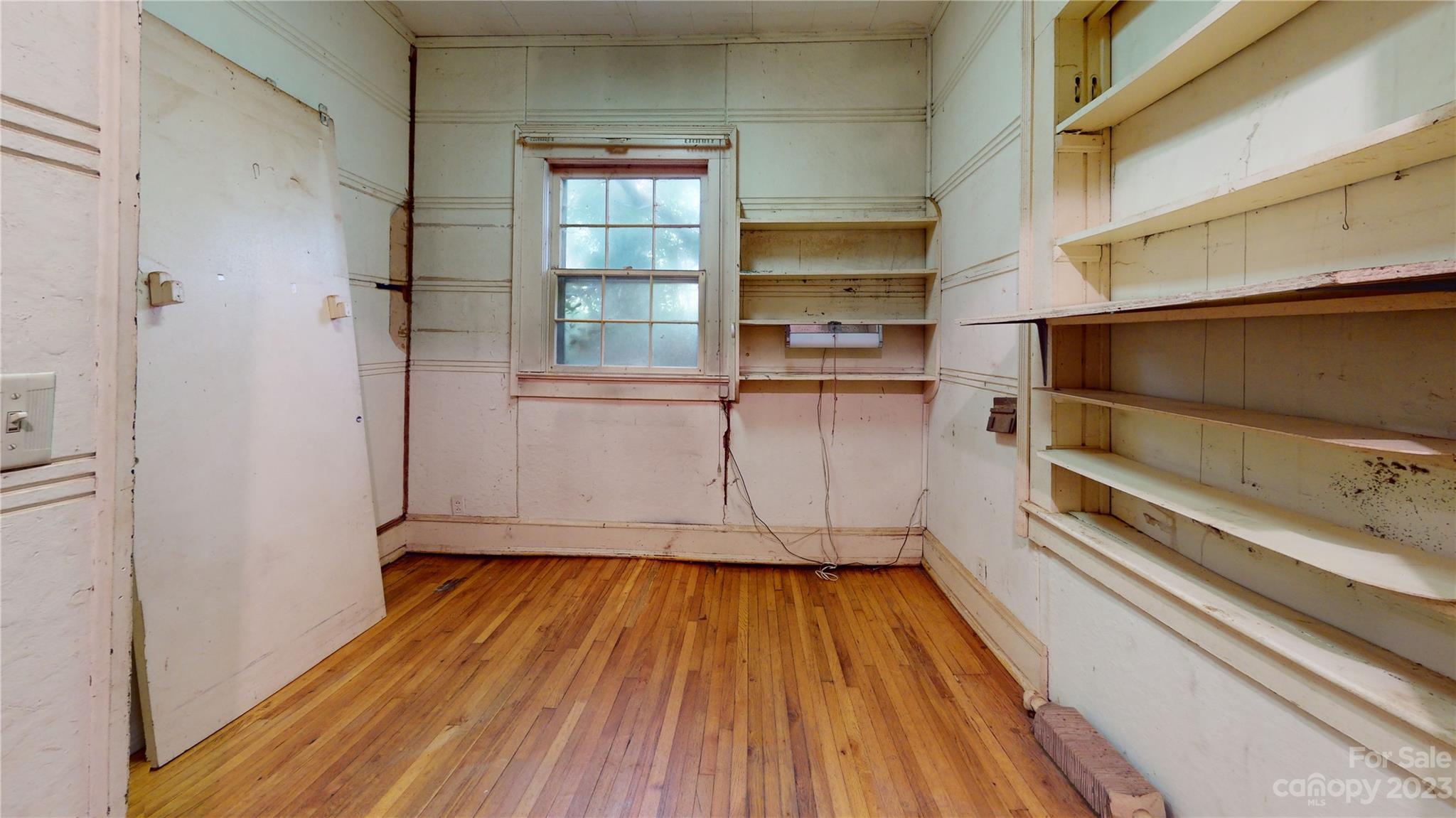 324 Buzzard's Roost Road Cullowhee, NC 28723 - Photo 16 of 18 a kitchen with white cabinets and wooden floor