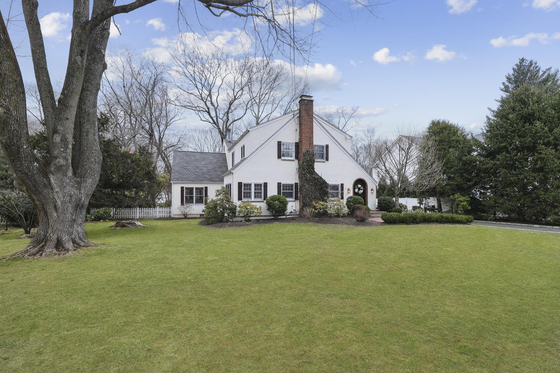 22 Birch Road Darien, CT 06820 - Photo 2 of 40 a front view of a house with a yard and trees